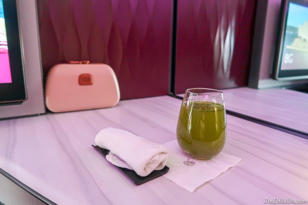 Refreshments right after boarding, still before take off, cold towel and a lime mint refresher non-alcoholic drink Qatar Airways Qsuite Business Class