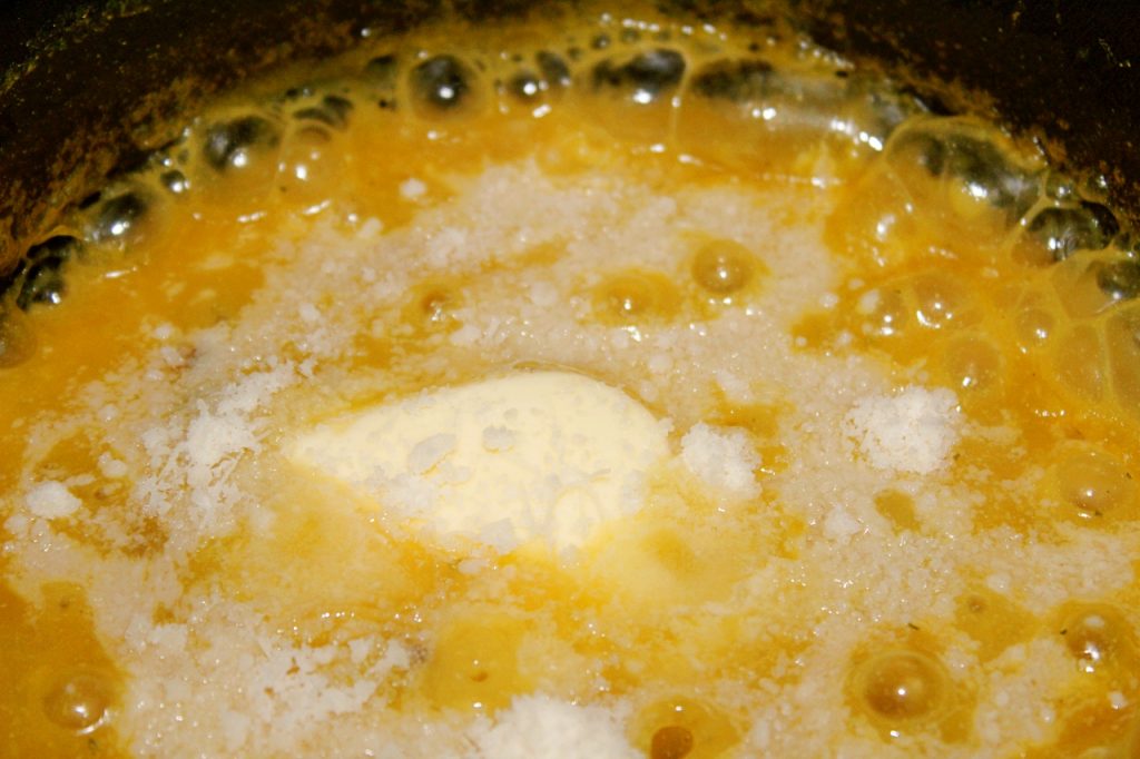 adding butter and parmesan cheese to the risotto