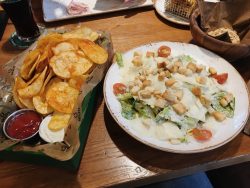 Crispy chips and caesar salad at QMUH in Ravensburg, Oberschwaben, Germany