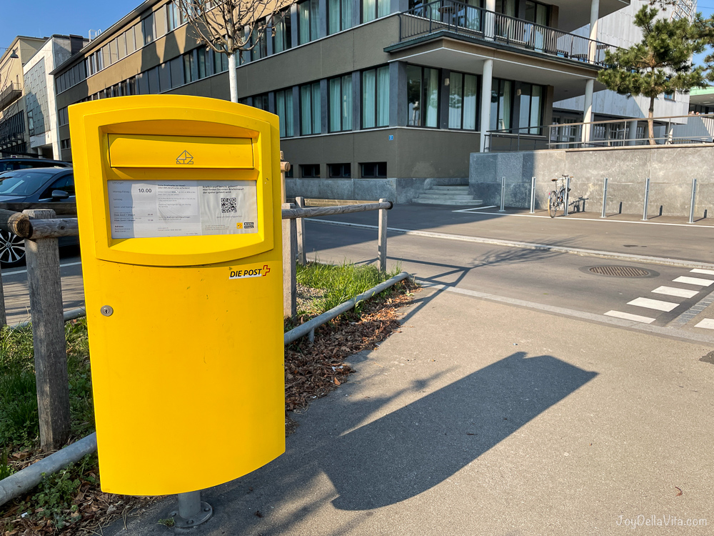 yellow postbox Zurich Switzerland street corner sunshine